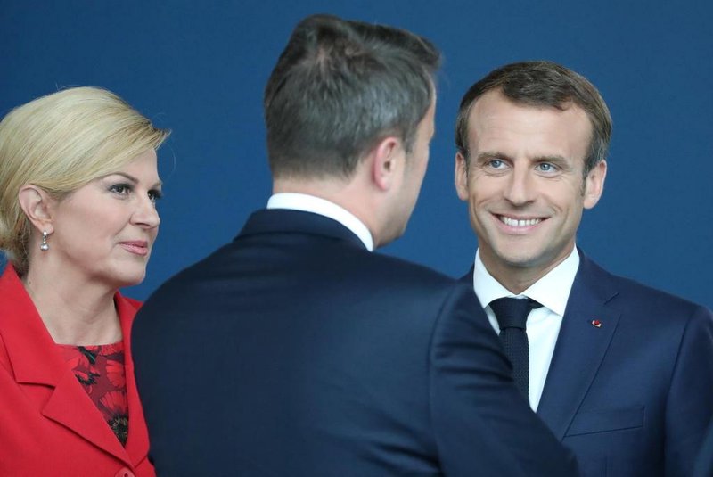 France's President Emmanuel Macron (2nd R), US President Donald Trump (R) and Croatia President Kolinda Grabar-Kitarovic arrive for the NATO (North Atlantic Treaty Organization) summit, at the NATO headquarters in Brussels, on July 11, 2018.  / AFP PHOTO / POOL / Tatyana ZENKOVICH