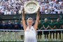Germanys Angelique Kerber poses with the winners trophy, the Venus Rosewater Dish, after her womens singles final victory over US player Serena Williams on the twelfth day of the 2018 Wimbledon Championships at The All England Lawn Tennis Club in Wimbledon, southwest London, on July 14, 2018.Kerber won the match 6-3, 6-3. / AFP PHOTO / Oli SCARFF / RESTRICTED TO EDITORIAL USE