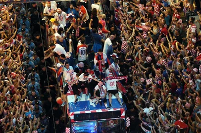 Croatian national football team players ride a bus as people gather for a 'heroes' welcome' in tribute to their national team, after reaching the final at the Russia 2018 World Cup, at the Bana Jelacica Square in Zagreb on July 16, 2018. / AFP PHOTO / Denis Lovrovic