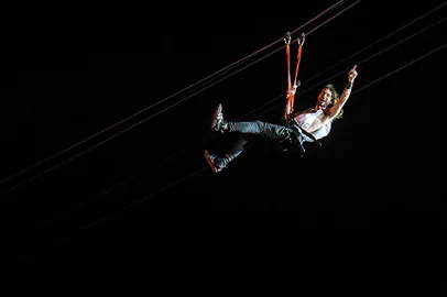 US singer Jared Leto, lead vocalist of 30 Seconds to Mars, performs on a zip-line during the Rock in Rio music festival in Rio de Janeiro, Brazil, on September 14, 2013. AFP PHOTO / YASUYOSHI CHIBA