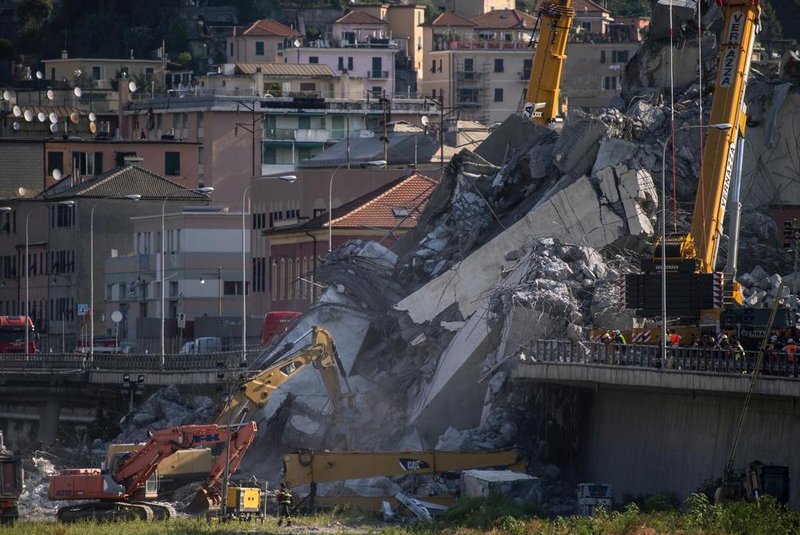 Rescuers work among the rubble and wreckage of the Morandi motorway bridge in Genoa on August 17, 2018, three days after a section collapsed.Rescue workers in Genoa have toiled for a third night in the wreckage of a collapsed bridge, continuing the desperate search for people still missing after the accident, which left at least 38 people dead. Italys populist government intensified its attacks on the viaduct operator amid rising anger over the tragedy and the structural problems that have dogged the decades-old Morandi bridge, which buckled without warning on August 14, sending about 35 cars and several trucks, along with huge chunks of concrete, plunging 45 metres (150 feet) onto railway tracks below. / AFP PHOTO / MARCO BERTORELLO