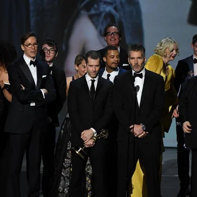 Writer-producers D.B. Weiss (C-L), David Benioff (C-R) and the cast of Game of Thrones accept the award Outstanding Drama series  onstage during the 70th Emmy Awards at the Microsoft Theatre in Los Angeles, California on September 17, 2018. / AFP PHOTO / Robyn Beck
