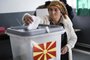 An Albanian woman casts her vote at a polling station in the village of Zajas on September 30, 2018, for a referendum to re-name the country.Macedonians cast ballots on September 30 on whether to re-name their country North Macedonia, a bid to settle a long-running row with Greece and unlock a path to NATO and EU membership. / AFP PHOTO / Armend NIMANI