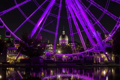 The dome of Bonsecours Market, as seen through Le Grande roue de Montreal, an observation wheel, in Old Montreal.UNDATED â BC-TRAVEL-TIMES-36-MONTREAL-ART-NYTSF â The dome of Bonsecours Market, as seen through Le Grande roue de Montreal, an observation wheel, in Old Montreal. Its cobblestone streets and French architecture make Old Montreal, the original settlement on the St. Lawrence Seaway, compelling. But the second largest city in Canada, now 376 years old, also has much to offer in its surrounding neighborhoods. From the new restaurants of Gay Village to the annually updated murals of the Plateau and the trendy shopping of Mile End, the cityâs districts make a strong case for buying a subway pass. (CREDIT: Christinne Muschi/The New York Times)âONLY FOR USE WITH ARTICLE SLUGGED -- BC-TRAVEL-TIMES-36-MONTREAL-ART-NYTSF -- OTHER USE PROHIBITED.Editoria: TRALocal: MONTREALIndexador: CHRISTINNE MUSCHIFonte: NYTNSFotógrafo: STR