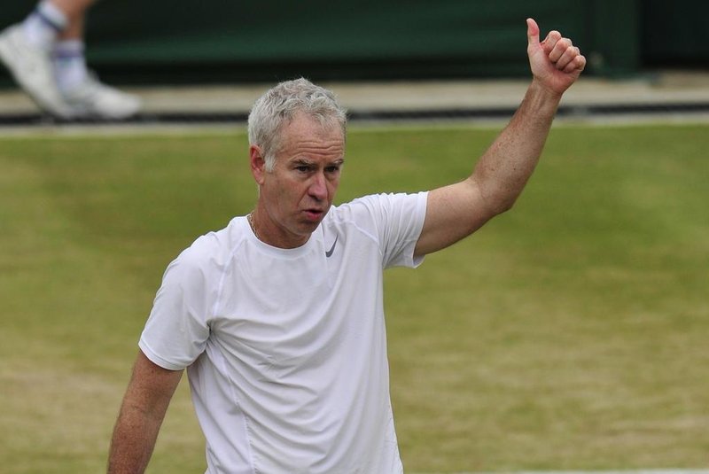 US players John McEnroe plays with Patrick McEnroe against Irans Mansour Bahrami and Frances Henri Leconte during a senior mens invitation doubles match on day nine of the 2013 Wimbledon Championships tennis tournament at the All England Club in Wimbledon, southwest London, on July 3, 2013. AFP PHOTO / GLYN KIRK  -  RESTRICTED TO EDITORIAL USE
