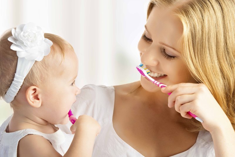 mother and daughter baby girl brushing their teeth togetherImportação Donnahttp://cdn.re