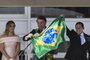  Brazils new President Jair Bolsonaro (C) and Brazils new Vice-President Hamilton Mourao (R), display a Brazilian national flag next to First Lady Michelle Bolsonaro, during their inauguration ceremony at Planalto Palace in Brasilia on January 1, 2019. - Bolsonaro takes office with promises to radically change the path taken by Latin Americas biggest country by trashing decades of centre-left policies. (Photo by EVARISTO SA / various sources / AFP)Editoria: POLLocal: BrasíliaIndexador: EVARISTO SASecao: governmentFonte: EVARISTO SAFotógrafo: STF