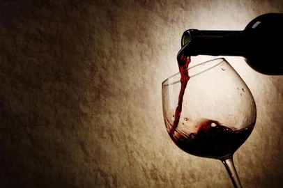 Red Wine glass and Bottle on a old stone background