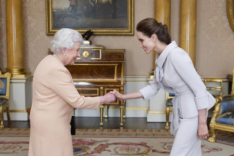 US actress Angelina Jolie (R) is presented with the Insignia of an Honorary Dame Grand Cro
