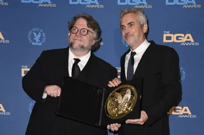 HOLLYWOOD, CALIFORNIA - FEBRUARY 02: Guillermo del Toro (L) and 2018 DGA Feature Film Award winner for Roma Alfonso Cuaron pose in the press room during the 71st Annual Directors Guild Of America Awards at The Ray Dolby Ballroom at Hollywood & Highland Center on February 02, 2019 in Hollywood, California.   Frazer Harrison/Getty Images/AFP