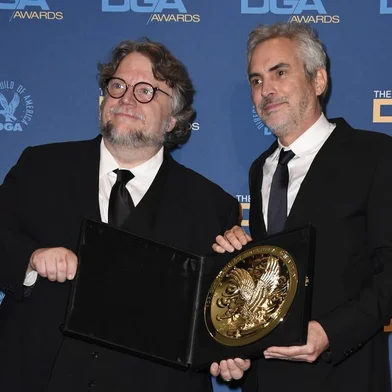 HOLLYWOOD, CALIFORNIA - FEBRUARY 02: Guillermo del Toro (L) and 2018 DGA Feature Film Award winner for Roma Alfonso Cuaron pose in the press room during the 71st Annual Directors Guild Of America Awards at The Ray Dolby Ballroom at Hollywood & Highland Center on February 02, 2019 in Hollywood, California.   Frazer Harrison/Getty Images/AFP