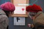 Two women look at the art work Love is in the Bin by British street artist Banksy at the Frieder Burda Museum in Baden-Baden, southwestern Germany, on February 5, 2019. - The art work which was partially destroyed during an auction at Sothebys will be presented in the museum until March 3, 2019. (Photo by Uli Deck / dpa / AFP) / Germany OUT / RESTRICTED TO EDITORIAL USE - MANDATORY MENTION OF THE ARTIST UPON PUBLICATION - TO ILLUSTRATE THE EVENT AS SPECIFIED IN THE CAPTION