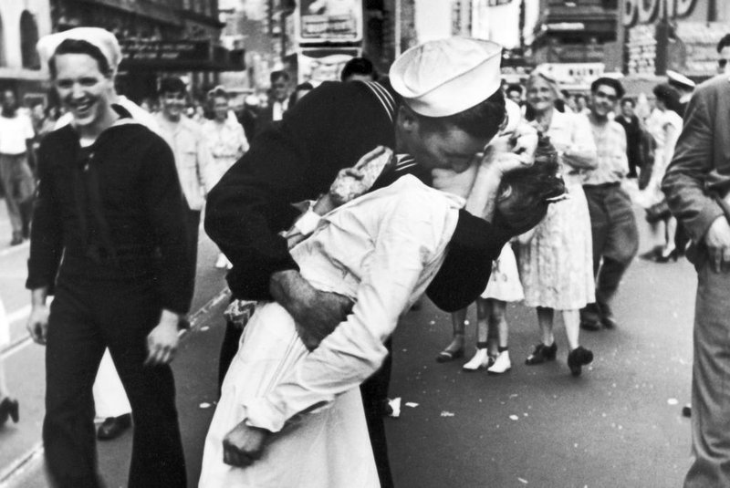 NEW YORK, UNITED STATES - AUGUST 14:  A jubilant American sailor clutching a white-uniformed nurse in a back-bending, passionate kiss as he vents his joy while thousands jam Times Square to celebrate the long awaited-victory over Japan.  (Photo by Alfred Eisenstaedt/Pix Inc./Time & Life Pictures/Getty Images)