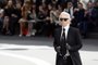 German fashion designer Karl Lagerfeld  for Chanel acknowledges the public during the Fall/Winter 2013-2014 ready-to-wear collection show, on March 5, 2013 at the Grand Palais in Paris. AFP PHOTO/PATRICK KOVARIK