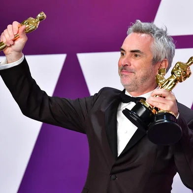 Best Director, Best Foreign Language Film, and Best Cinematography winner for Roma Alfonso Cuaron poses in the press room with his Oscars during the 91st Annual Academy Awards at the Dolby Theatre in Hollywood, California on February 24, 2019. (Photo by FREDERIC J. BROWN / AFP)
