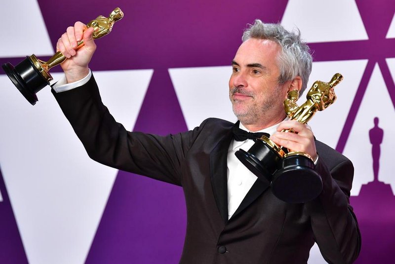 Best Director, Best Foreign Language Film, and Best Cinematography winner for Roma Alfonso Cuaron poses in the press room with his Oscars during the 91st Annual Academy Awards at the Dolby Theatre in Hollywood, California on February 24, 2019. (Photo by FREDERIC J. BROWN / AFP)