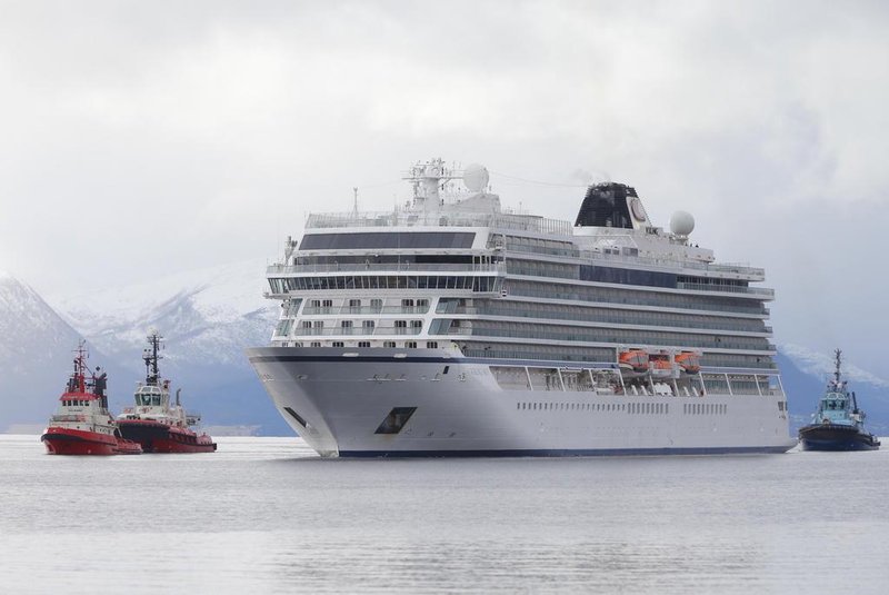 The cruise ship Viking Sky, that ran into trouble in stormy seas off Norway, reaches the port of Molde under its own steam on March 24, 2019. - Escorted by tugboats, the Viking Sky arrived at the port of Molde. Nearly a third of its 1,373 passengers and crew had already been airlifted off the ship after it lost power along a stretch of Norwegian coastline notorious for shipwrecks. (Photo by Svein Ove EKORNESVAAG / NTB scanpix / AFP) / Norway OUT