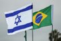 This picture taken on March 31, 2019 shows the flags of Israel and Brazil flying together at Tel Aviv Ben Gurion International Airport, ahead of the arrival of the Brazilian president for his first visit to Israel. (Photo by Jack GUEZ / AFP)