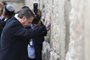 Brazilian President Jair Bolsonaro (foreground) and Israeli Prime Minister Benjamin Netanyahu (background) pray at the Western wall, the holiest site where Jews can pray, in the Old City of Jerusalem on April 1, 2019. - Bolsonaro visited the Western Wall alongside Netanyahu on Monday, becoming the first head of state to do so with an Israeli premier. The site, one of the holiest in Judaism, is located in east Jerusalem, occupied by Israel in the 1967 Six-Day War and later annexed in a move never recognised by the international community. (Photo by Menahem KAHANA / POOL / AFP)