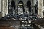  A picture taken on April 16, 2019 shows the altar surrounded by charred debris inside the Notre-Dame Cathedral in Paris in the aftermath of a fire that devastated the cathedral. - French investigators probing the devastating blaze at Notre-Dame Cathedral on April 15, 2019, questioned workers who were renovating the monument on April 16, as hundreds of millions of euros were pledged to restore the historic masterpiece. As firefighters put out the last smouldering embers, a host of French billionaires and companies stepped forward with offers of cash worth around 600 million euros ($680 million) to remake the iconic structure. (Photo by LUDOVIC MARIN / AFP)Editoria: DISLocal: ParisIndexador: LUDOVIC MARINSecao: fireFonte: AFPFotógrafo: STF