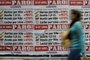 A woman walks past banners placed by the Argentinian bank workers union showing how much food prices have increased since the beginning of the government of Argentinas President Mauricio Macri and calling a strike for next April 30 at the financial district in Buenos Aires, on April 25, 2019. - Since his election in 2015, the market-friendly former Buenos Aires mayor has launched important economic reforms to balance years of spending by the previous leftist government of Cristina Kirchner -- but his promises to defeat inflation and place Argentina on the path to sustained growth have proved empty. (Photo by JUAN MABROMATA / AFP)