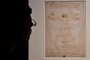 (FILES) In this file photo taken on May 13, 2015 a visitor looks at the Leonardos piece Vitruvian Man presented at the Palazzo Reale museum as part of the exhibition Leonardo Da Vinci on May 13, 2015 in Milan. - May 2019 marks the 500th anniversary of the death of Italian Renaissance master Leonardo da Vinci. (Photo by Giuseppe CACACE / AFP) / RESTRICTED TO EDITORIAL USE - MANDATORY MENTION OF THE ARTIST UPON PUBLICATION - TO ILLUSTRATE THE EVENT AS SPECIFIED IN THE CAPTION