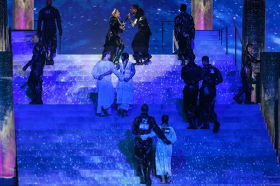 This handout photo released by KAN shows Madonna and US rapper Quavo performing during a guest appearance at the 64th edition of the Eurovision Song Contest 2019 at Expo Tel Aviv on May 19, 2019, in the Israeli coastal city of Tel Aviv. - Two of Madonnas dancers are pictured (foreground)  side-by-side with Israeli and Palestinian flags on their backs during her performance in an apparent call for unity. (Photo by Orit Pnini / KAN / AFP) / RESTRICTED TO EDITORIAL USE - MANDATORY CREDIT AFP PHOTO / KAN / ORIT PNINI   - NO MARKETING NO ADVERTISING CAMPAIGNS - DISTRIBUTED AS A SERVICE TO CLIENTS