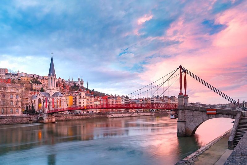 Saint Georges church and footbridge across Saone river, Old town with Fourviere cathedral at gorgeous sunset in Lyon, France; Shutterstock ID 1068639002; Your name (First / Last): Jack Palfrey; GL account no.: 65050; Netsuite department name: Online Editorial; Full Product or Project name including edition: Best in Europe 2019 campaign 