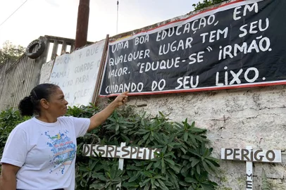 Mora coloca faixas em frente de casa para alertar contra lixo na rua