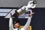 Winner Mercedes British driver Lewis Hamilton celebrates with his trophy on the podium after the Formula One Grand Prix de France at the Circuit Paul Ricard in Le Castellet, southern France, on June 23, 2019. (Photo by GERARD JULIEN / AFP)