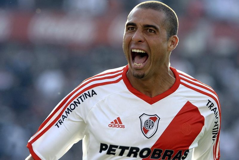 River Plates forward David Trezeguet celebrates with teammates after scoring the teams first goal against Almirante Brown during their Argentine Second Division football match, at the Monumental stadium in Buenos Aires, Argentina, on June 23, 2012.  AFP PHOTO / Alejandro PAGNI
