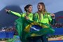  SAILING-OLY-2016-RIOGold medallists Brazil's Martine Grael and Brazil's Kahena Kunze celebrate on the podium of the 49er FX Women medal race at Marina da Gloria during the Rio 2016 Olympic Games in Rio de Janeiro on August 18, 2016. WILLIAM WEST / AFPEditoria: SPOLocal: Rio de JaneiroIndexador: WILLIAM WESTSecao: sailingFonte: AFPFotógrafo: STF