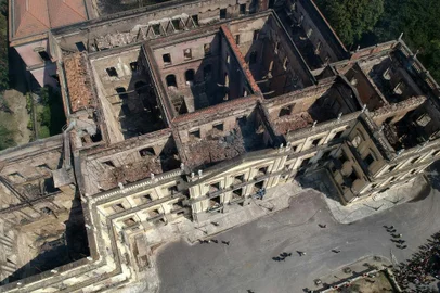 Aerial view of Rio de Janeiros treasured National Museum, one of Brazils oldest, on September 3, 2018, a day after a massive fire ripped through the building. The majestic edifice stood engulfed in flames as plumes of smoke shot into the night sky, while firefighters battled to control the blaze that erupted around 2230 GMT. Five hours later they had managed to smother much of the inferno that had torn through hundreds of rooms, but were still working to extinguish it completely. / AFP PHOTO / Mauro Pimentel