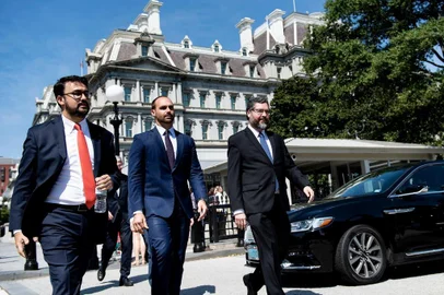 Eduardo Bolsonaro (C), son of Brazils President Jair Bolsonaro, and Brazils Foreign Minister Ernesto Araujo (R) walk after a meeting at the White House on August 30, 2019, in Washington, DC. (Photo by Brendan Smialowski / AFP)