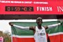 Kenyas Eliud Kipchoge (white jersey) celebrates after busting the mythical two-hour barrier for the marathon on October 12 2019 in Vienna. - Kipchoge holds the mens world record for the distance with a time of 2hr 01min 39sec, which he set in the flat Berlin marathon on September 16, 2018.He tried in May 2017 to break the two-hour barrier, running on the Monza National Autodrome racing circuit in Italy, failing narrowly in 2hr 00min 25sec. (Photo by HERBERT NEUBAUER / APA / AFP) / Austria OUT