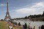 People bathe in the Trocadero Fountain near the Eiffel Tower in Paris during a heatwave on June 28, 2019. - The temperature in France on June 28 surpassed 45 degrees Celsius (113 degrees Fahrenheit) for the first time as Europe wilted in a major heatwave, state weather forecaster Meteo-France said. (Photo by Zakaria ABDELKAFI / AFP)