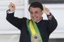  Brazils new president Jair Bolsonaro gestures after receiveing the presidential sash from outgoing Brazilian president Michel Temer (out of frame), at Planalto Palace in Brasilia on January 1, 2019. - Bolsonaro takes office with promises to radically change the path taken by Latin Americas biggest country by trashing decades of centre-left policies. (Photo by EVARISTO SA / AFP)Editoria: POLLocal: BrasíliaIndexador: EVARISTO SASecao: governmentFonte: AFPFotógrafo: STF