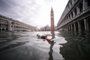 A general view shows a bottle of wine floating on the water of the flooded St. Marks Square, with St. Marks Basilica (Rear L) and the Bell Tower on November 15, 2019 in Venice, two days after the city suffered its highest tide in 50 years. - Flood-hit Venice was bracing for another exceptional high tide on November 15, as Italy declared a state of emergency for the UNESCO city where perilous deluges have caused millions of euros worth of damage. (Photo by Filippo MONTEFORTE / AFP)