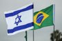 This picture taken on March 31, 2019 shows the flags of Israel and Brazil flying together at Tel Aviv Ben Gurion International Airport, ahead of the arrival of the Brazilian president for his first visit to Israel. (Photo by Jack GUEZ / AFP)