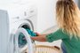 Young woman, load the wash machine for cleaning laundrys Young woman, load the wash machine for cleaning laundrys .Fonte: 293577407