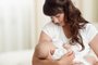 Young mother feeding breast her baby at home in white roomYoung mother feeding breast her newborn baby at home in white roomFonte: 250585687<!-- NICAID(14357572) -->