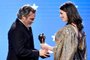SANTA MONICA, CALIFORNIA - JANUARY 12: (L-R) Joaquin Phoenix accepts the Best Actor award for Joker from Anne Hathaway onstage during the 25th Annual Critics Choice Awards at Barker Hangar on January 12, 2020 in Santa Monica, California.   Amy Sussman/Getty Images/AFP<!-- NICAID(14385025) -->