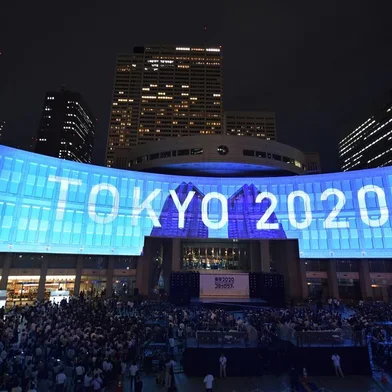 A projection that reads Tokyo 2020 is seen during a ceremony marking three years to go before the start of the Tokyo 2020 Olympic games at the Tokyo Metropolitan Assembly Building on July 24, 2017.Japan marked three years before the 2020 Tokyo Olympics on July 24 with celebration and fanfare -- even as organisers struggle to contain soaring costs and restore credibility. / AFP PHOTO / Kazuhiro NOGI<!-- NICAID(13049452) -->