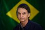 O candidato à Presidência da República pelo PSL, Jair Bolsonaro, vota no primeiro turno das Eleições 2018 na Vila Militar, em Marechal Hermes, na zona norte da cidade, neste domingo, 7.Brazils right-wing presidential candidate for the Social Liberal Party (PSL) Jair Bolsonaro walks in front of the Brazilian flag as he prepares to cast his vote during the general elections, in Rio de Janeiro, Brazil, on October 7, 2018.Polling stations opened in Brazil on Sunday for the most divisive presidential election in the country in years, with far-right lawmaker Jair Bolsonaro the clear favorite in the first round. About 147 million voters are eligible to cast ballots and choose who will rule the worlds eighth biggest economy. New federal and state legislatures will also be elected. / AFP PHOTO / Mauro PIMENTELEditoria: POLLocal: Rio de JaneiroIndexador: MAURO PIMENTELSecao: electionFonte: AFPFotógrafo: STF<!-- NICAID(13774277) -->