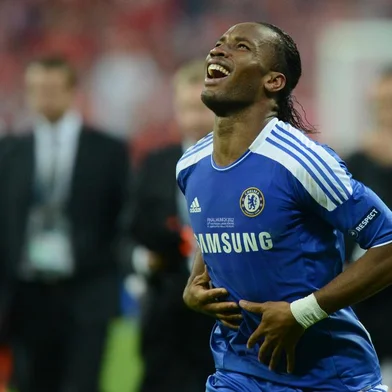 Chelseas Ivorian forward Didier Drogba celebrates after scoring a goal during the UEFA Champions League final football match between FC Bayern Muenchen and Chelsea FC on May 19, 2012 at the Fussball Arena stadium in Munich.. AFP PHOTO / ADRIAN DENNIS (Photo by ADRIAN DENNIS / AFP)<!-- NICAID(13842464) -->