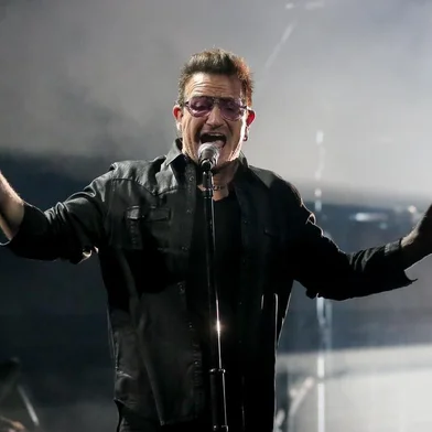 Irish singer-songwriter Bono performs with his band U2 during the Bambi awards on November 13, 2014 in Berlin. The Bambis are the main German media awards.     AFP PHOTO / DPA / WOLFGANG KUMM / GERMANY OUT<!-- NICAID(10997163) -->