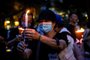 Activists light candles during a remembrance gathering outside Victoria Park in Hong Kong on June 4, 2020, after an annual vigil that traditionally takes place in the park to mark the 1989 Tiananmen Square crackdown was banned on public health grounds because of the COVID-19 coronavirus pandemic. (Photo by ISAAC LAWRENCE / AFP)<!-- NICAID(14515110) -->