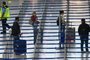 Passengers stand at the check-in for their flight to Mallorca at the Duesseldorf airport, western Germany, on June 15, 2020. - From Monday, June 15, 2020 onwards, German holidaymakers will again be able to travel to the Balearic Islands of Mallorca, Ibiza, Menorca and Formentera. The airports in the western federal state of North Rhine-Westphalia expect air traffic to gradually increase again after the travel warning for most European countries has been lifted. (Photo by Ina FASSBENDER / AFP)<!-- NICAID(14522645) -->