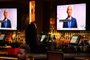 Former US President Barack Obama is seen on television screens as he speaks during the third day of the Democratic National Convention, being held virtually amid the novel coronavirus pandemic, at The Abbey bar and restaurant in West Hollywood, California, August 19, 2020. (Photo by Robyn Beck / AFP)