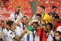  Sevillas Brazilian midfielder Fernando lifts the trophy as he celebrates with teammates after Sevilla won the UEFA Europa League final football match Sevilla v Inter Milan on August 21, 2020 in Cologne, western Germany. (Photo by Lars Baron / POOL / AFP)Editoria: SPOLocal: CologneIndexador: LARS BARONSecao: soccerFonte: POOLFotógrafo: STR<!-- NICAID(14574213) -->